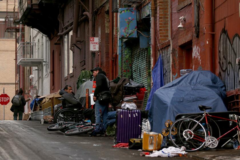 San Francisco, CA - Men loiter in a homeless encampment in an alley off Grant Street in San Francisco's Chinatown. Steeped in history, culture and wealth, San Francisco now has a dubious reputation for intractable homelessness, rampant crime and an exodus of business. (Luis Sinco / Los Angeles Times)