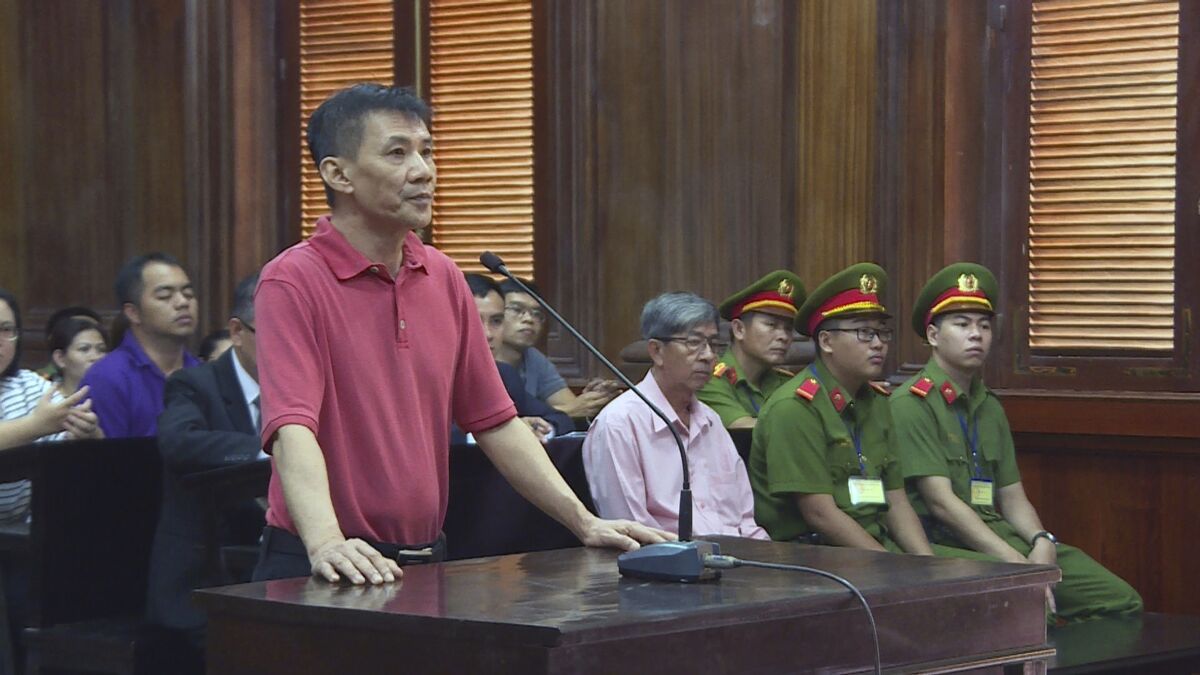 Michael Nguyen stands in a courtroom.