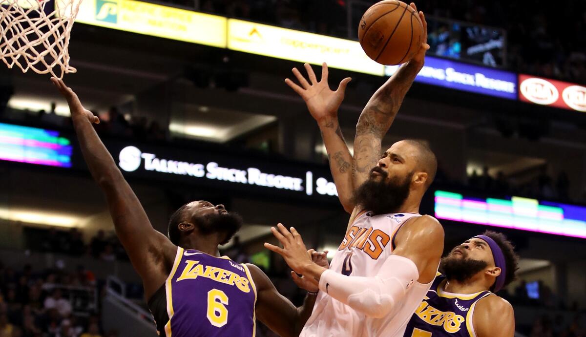 Tyson Chandler tries to dunk against the Lakers' Lance Stephenson (6) and JaVale McGee while playing for the Suns earlier this season.