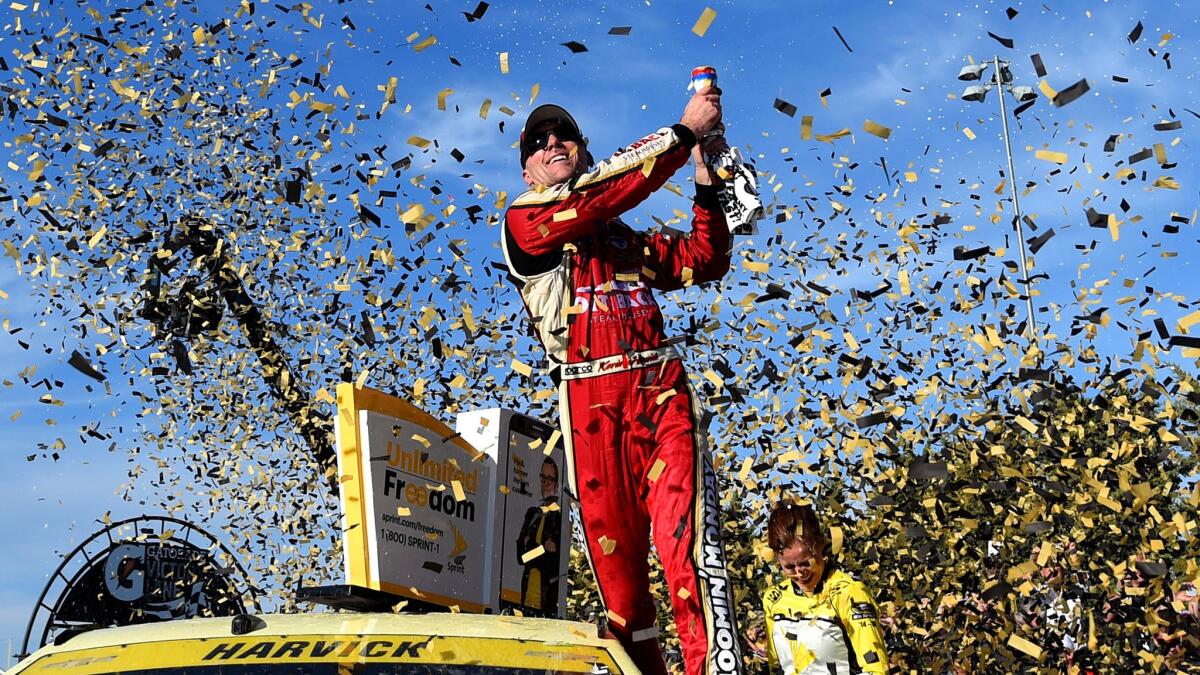 NASCAR driver Kevin Harvick celebrates after winning the Sprint Cup Hollywood Casino 400 at Kansas Speedway on Sunday.