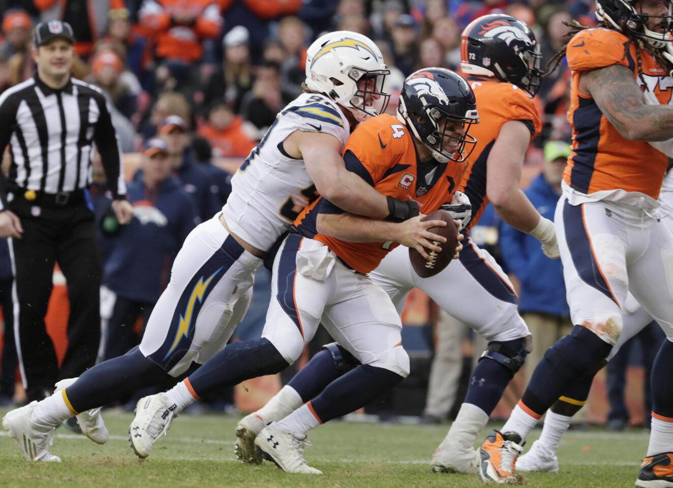 Chargers defensive end Joey Bosa sacks Broncos quarterback Case Keenum during a second quarter drive at Mile High Stadium.