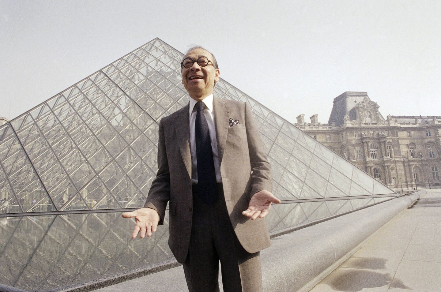 I.M. Pei in front of the Louvre glass pyramid, which he designed, in the museum's Napoleon Courtyard, before its inauguration in Paris.