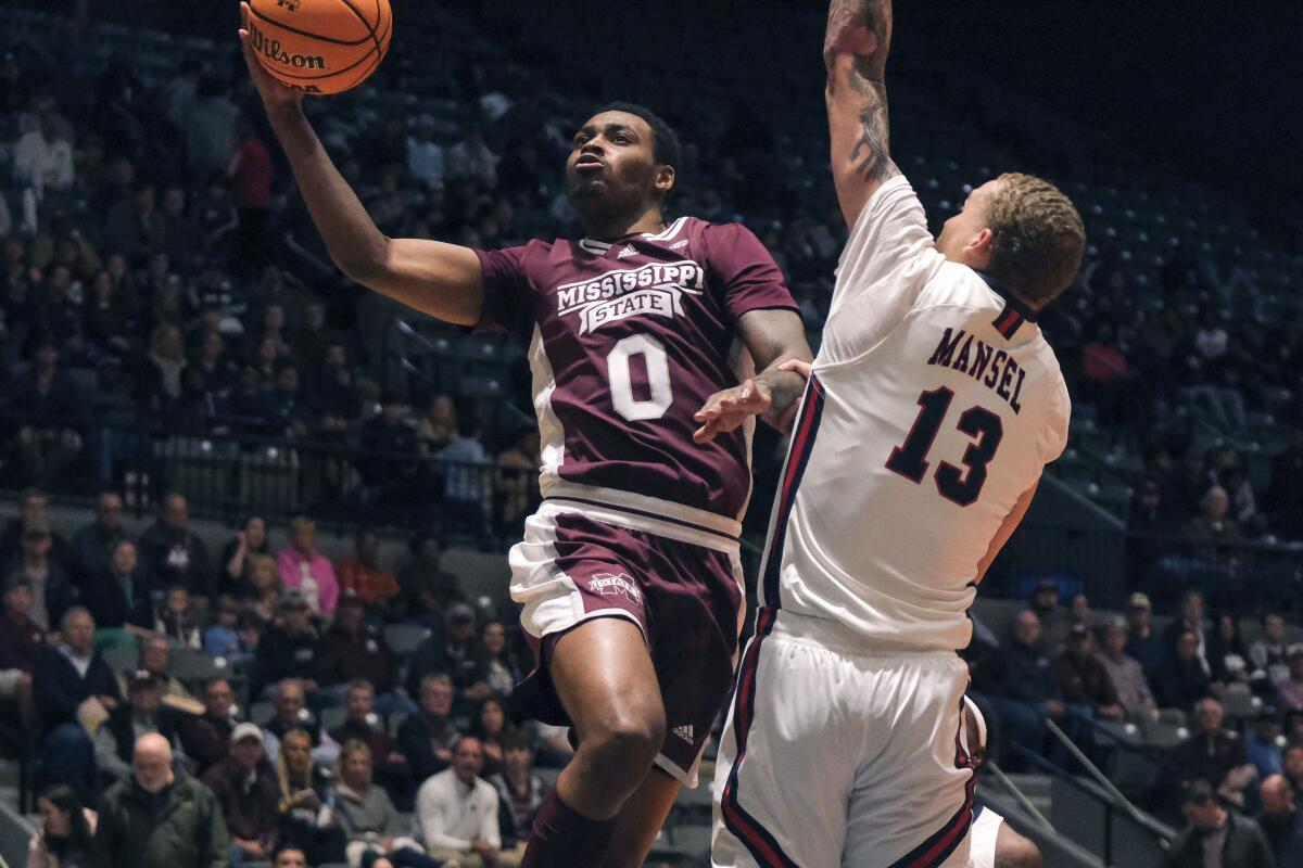 Mississippi State forward D.J. Jeffries (0) takes a lay up against Jackson State forward Romelle Mansel (13) during the first half of an NCAA college basketball game in Jackson, Miss., Wednesday, Dec. 14, 2022. (AP Photo/HG Biggs)