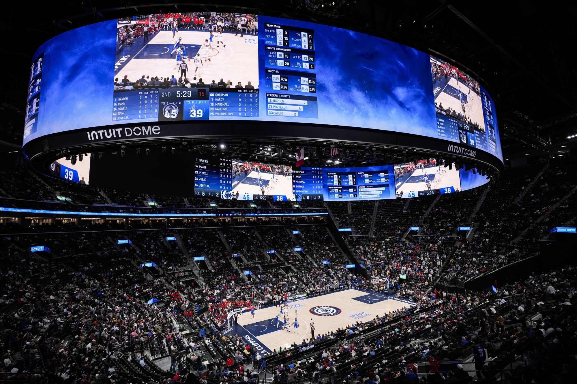 Fans watch the Clippers play a preseason game in the new, $2 billion Intuit Dome. 