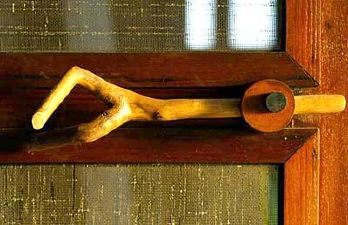 A bolt that was once a branch is one of the carved latches  no two alike  throughout the house.