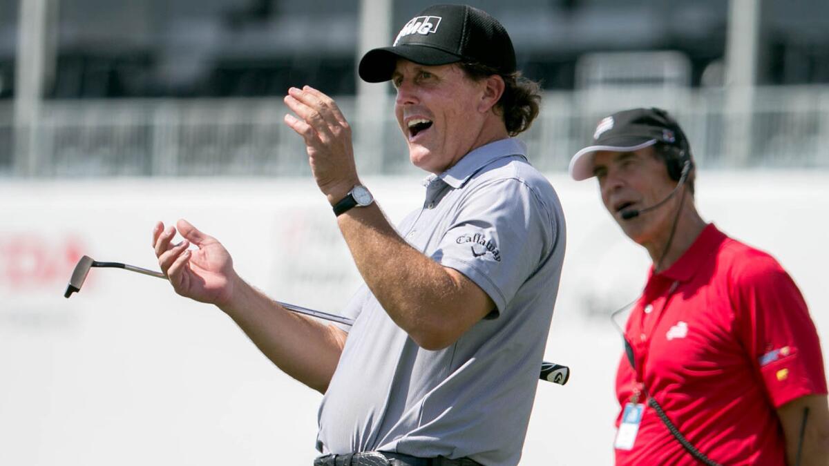 Phil Mickelson applauds after his playing partner made a birdie putt on the 18th hole of the Honda Classic Pro-Am in Palm Beach Gardens, Fla., on Wednesday.