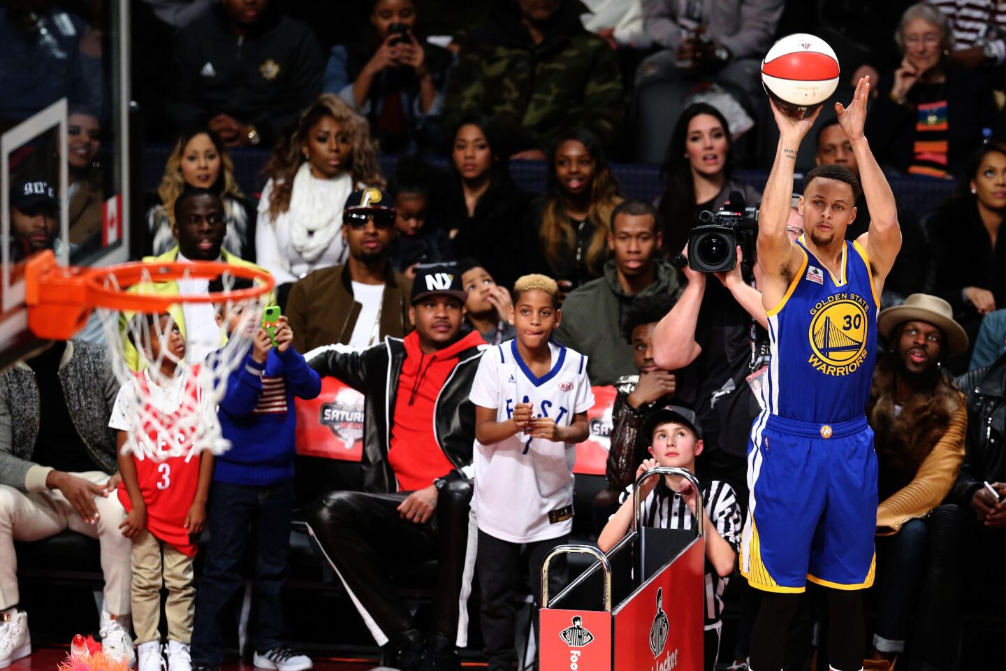 Warriors point guard Stephen Curry takes a shot during the Three-Point Contest on Saturday. The defending champion would be beaten by teammate Klay Thompson.