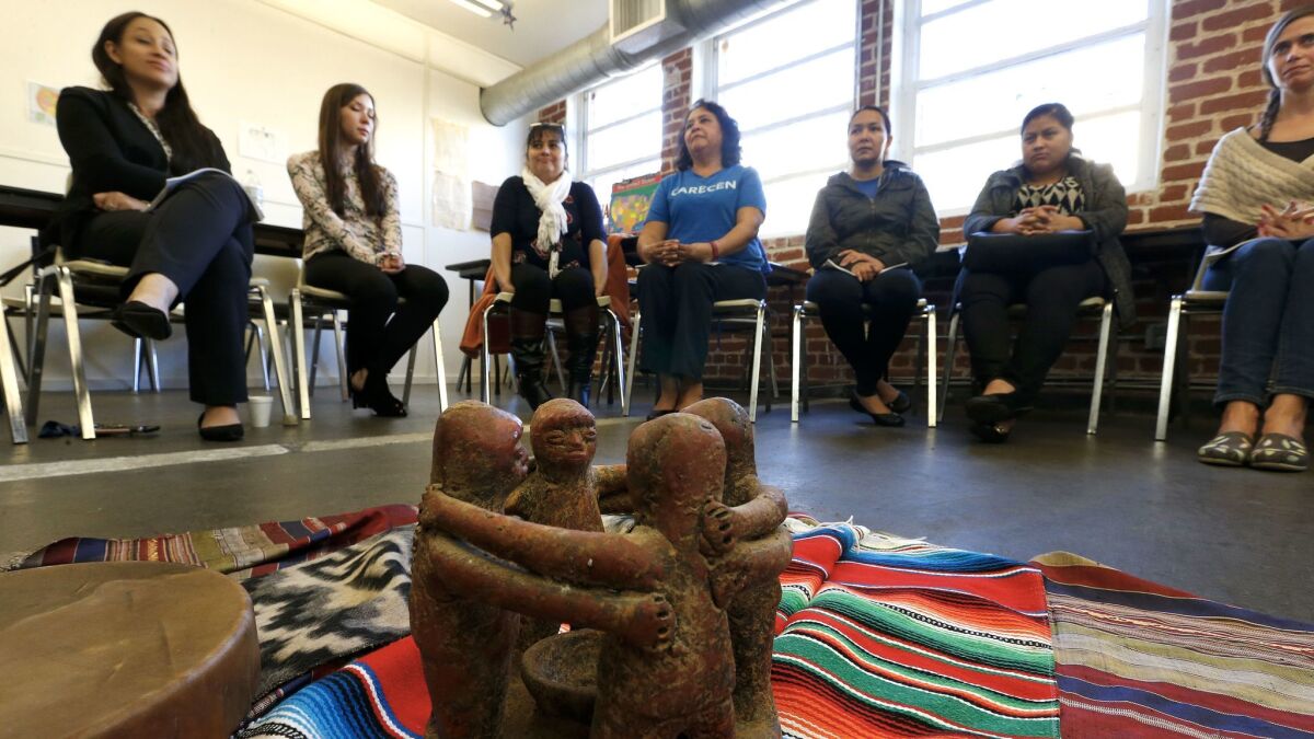 A circle of friends ceramic piece from Peru is placed inside a reflection and healing circle during a workshop for members of the immigrants right organization Carecen in Los Angeles.