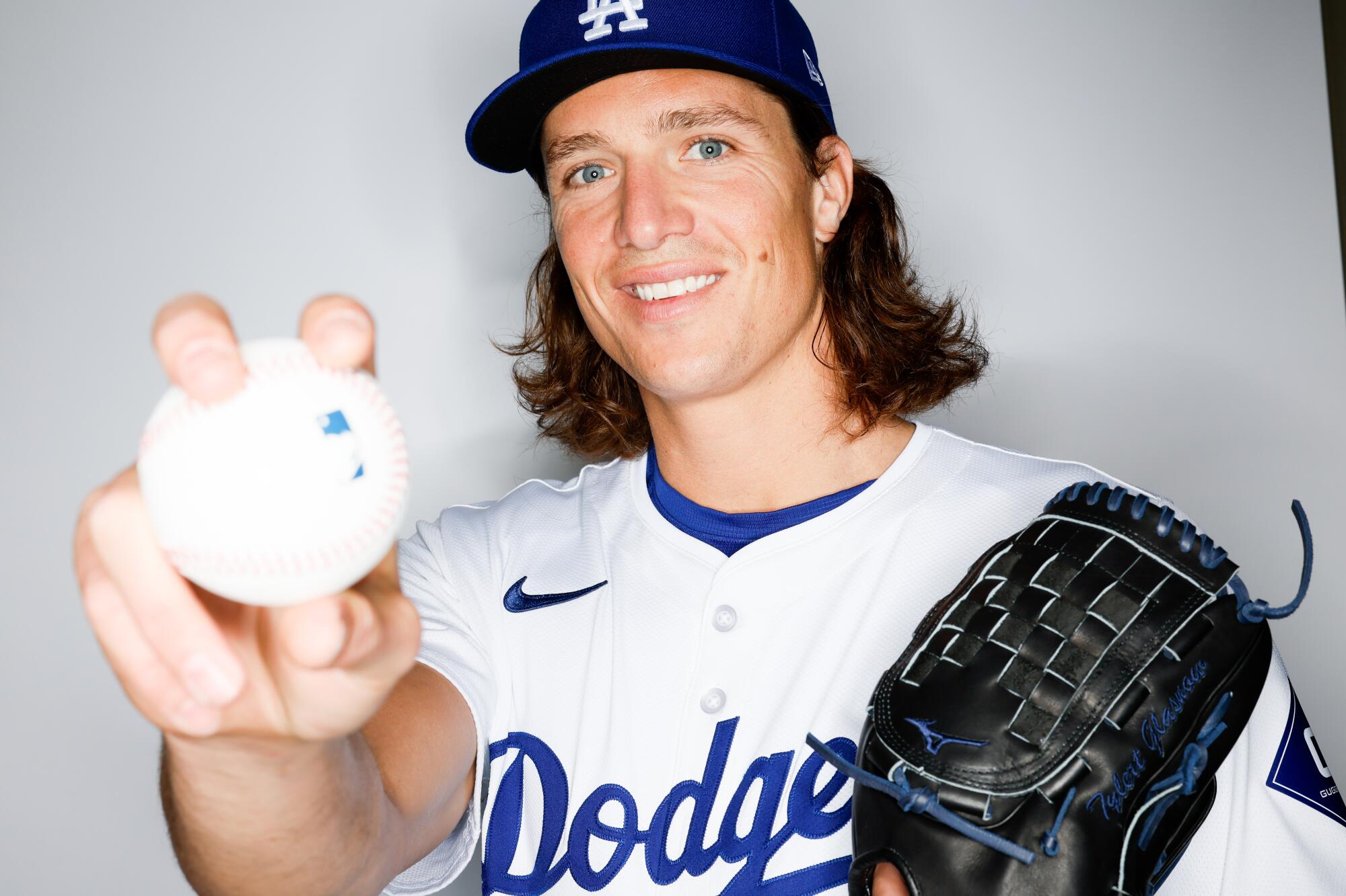 Portrait of Dodgers pitcher Tyler Glasnow at spring training holding a baseball.