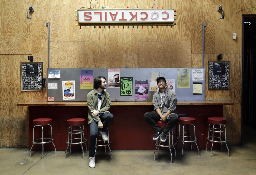 Kyle Wilkerson, left, and marketing director Tommy Sugimoto at the closed Bootleg Theater in Los Angeles. 