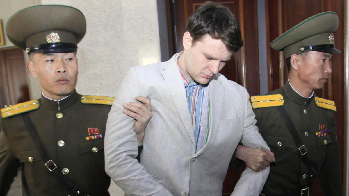 American student Otto Warmbier is escorted at the Supreme Court in Pyongyang, North Korea, Wednesday, March 16, 2016.