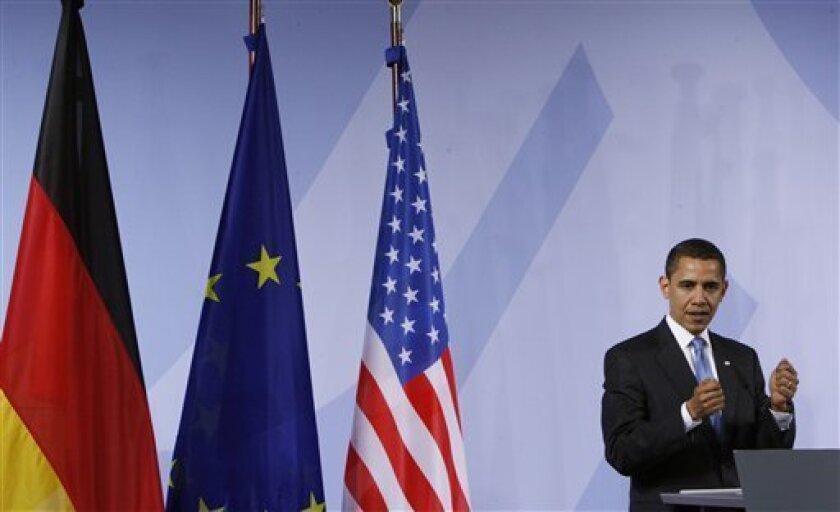 President Barack Obama gestures during a joint news conference with German Chancellor Angela Merkel, not shown, Friday, April 3, 2009, at Rathaus in Baden-Baden, Germany. (AP Photo/Pablo Martinez Monsivais)