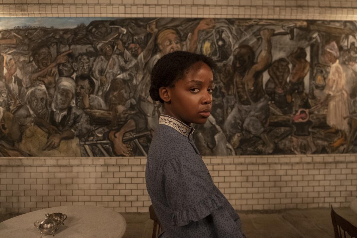 Thuso Mbedu stands in front of a mural in "The Underground Railroad"