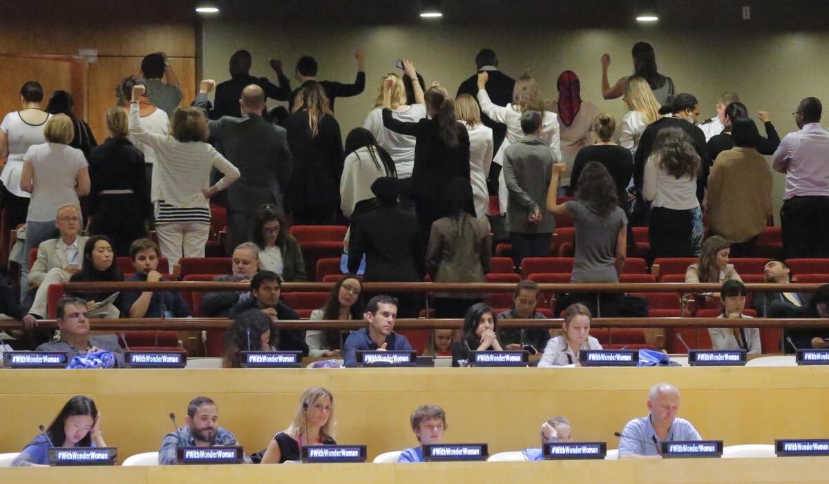 United Nations staff members turn their backs in protest during an event where the Wonder Woman character was designated as an Honorary Ambassador for the Empowerment of Women and Girls.