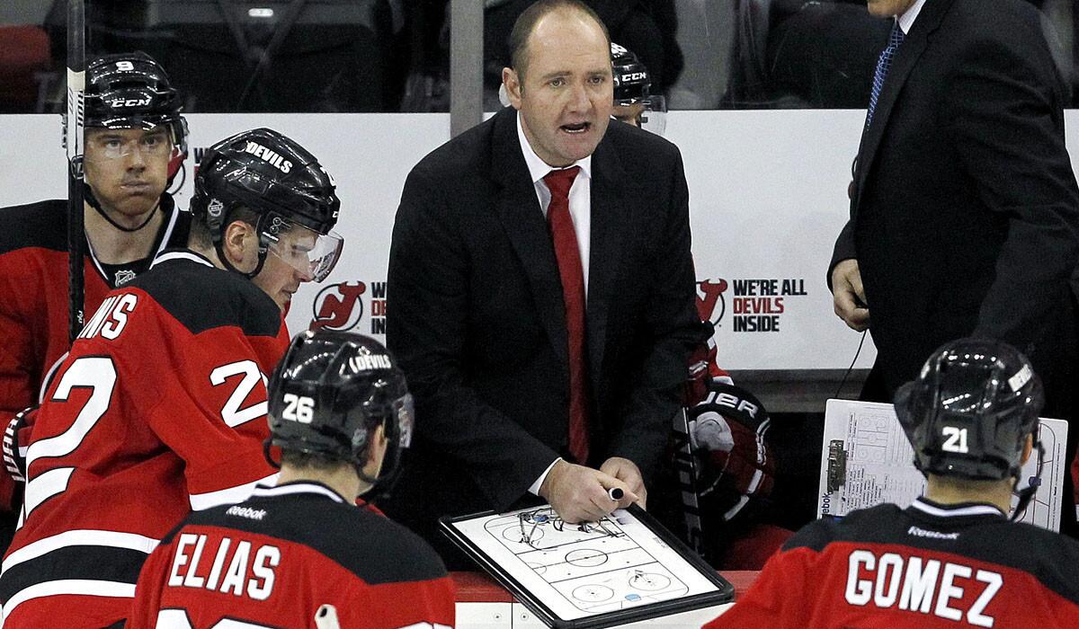 Peter DeBoer talks to Devils players during a game last week against Ottawa.