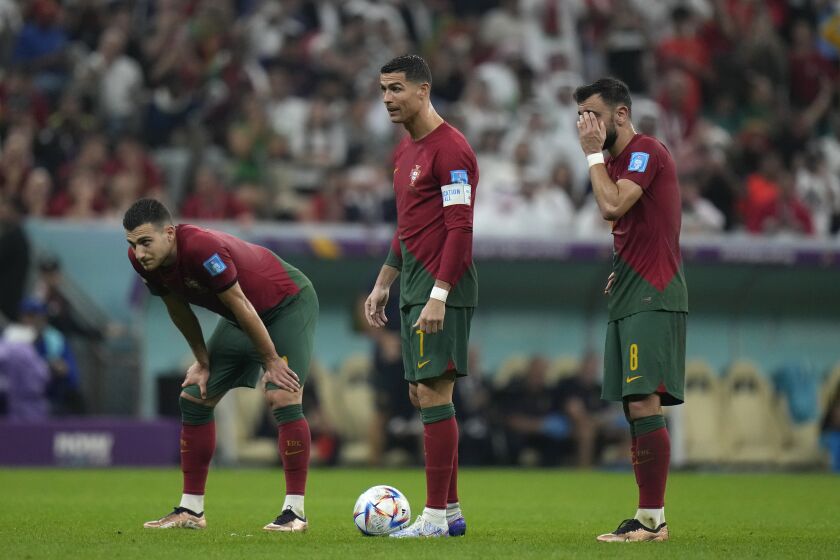 Portugal's Cristiano Ronaldo, center, stands with his teammates during the World Cup round of 16 soccer match between Portugal and Switzerland, at the Lusail Stadium in Lusail, Qatar, Tuesday, Dec. 6, 2022. (AP Photo/Alessandra Tarantino)