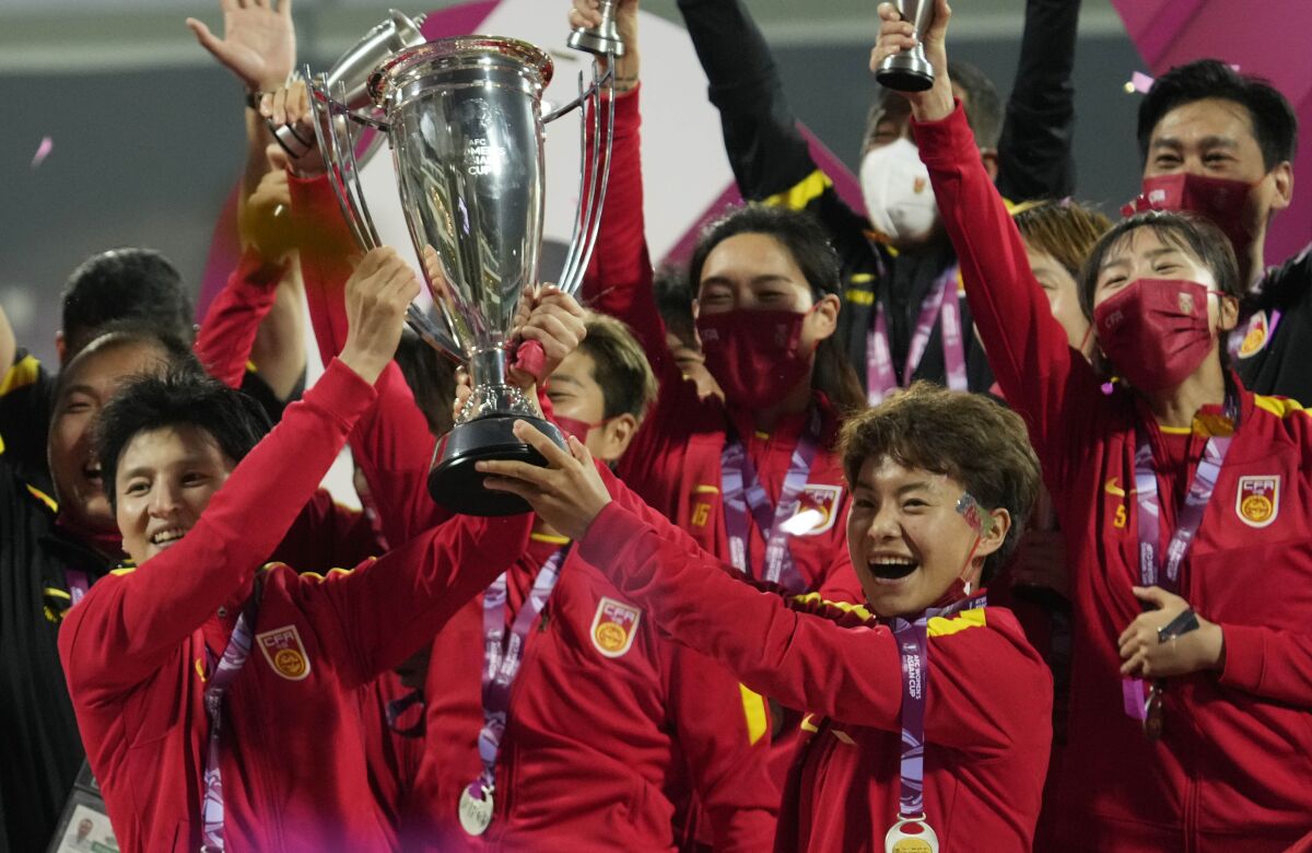 Chinese players pose with trophy after winning the AFC Women's Asian Cup 2022 in Mumbai, India, Sunday, Feb. 6, 2022. (AP Photo/Rajanish Kakade)