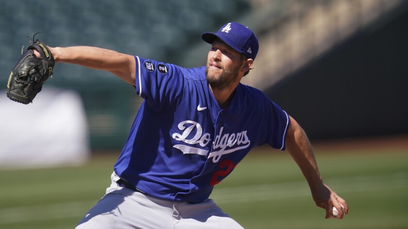 Los Angeles Dodgers' Clayton Kershaw pitches in a spring training baseball game against the Kansas City Royals.