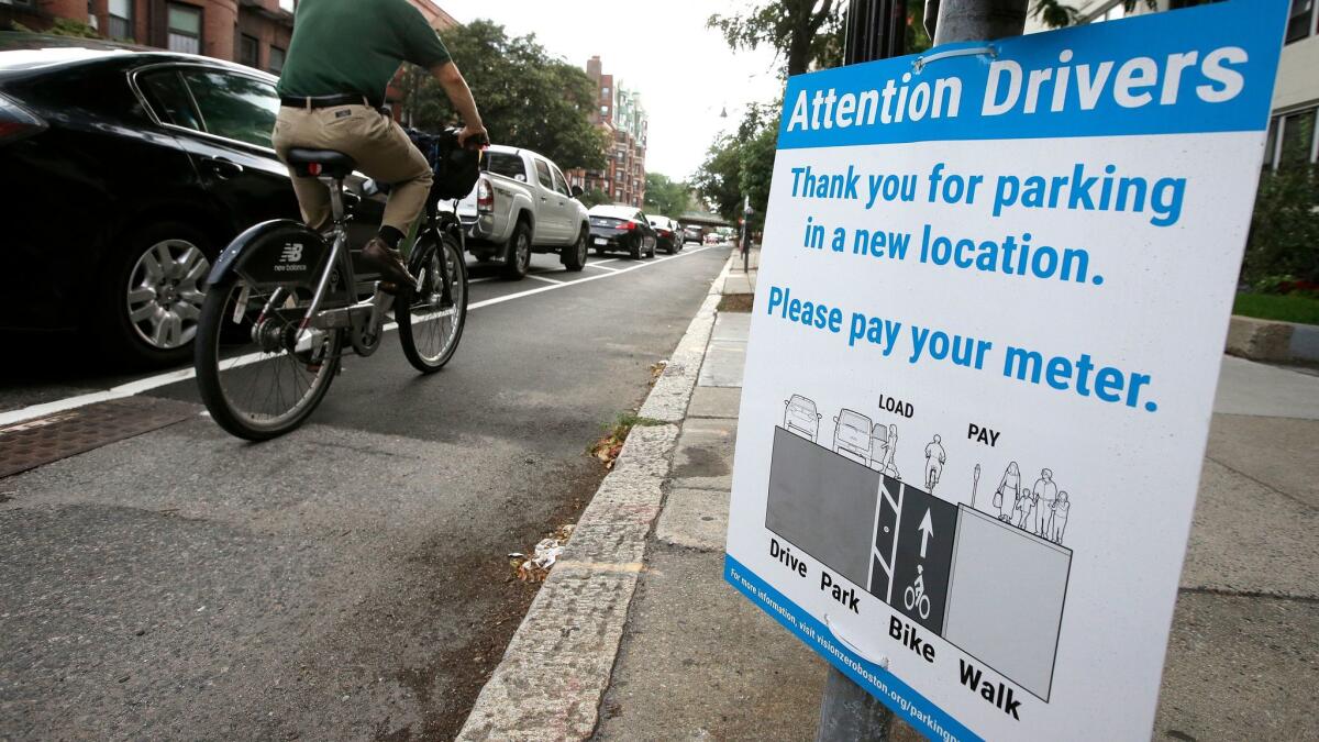 Cities around the world are increasingly redesigning streets to make them safer for cyclists. Above, a protected bicycle lane in Boston. Los Angeles has been slow to implement similar changes. (Steven Senne / Associated Press)