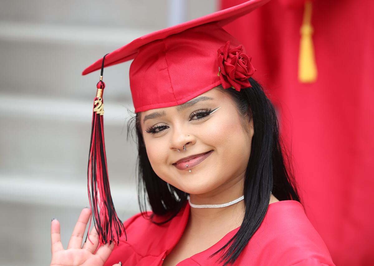 Rosemary Garcia waves to family before the Back Bay High School commencement ceremony.