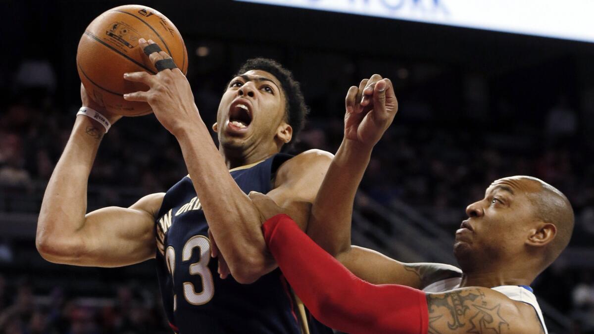 New Orleans Pelicans forward Anthony Davis, left, is fouled by Detroit Pistons forward Caron Butler during a game on Jan. 14. Davis has developed into one of the NBA's biggest young stars.