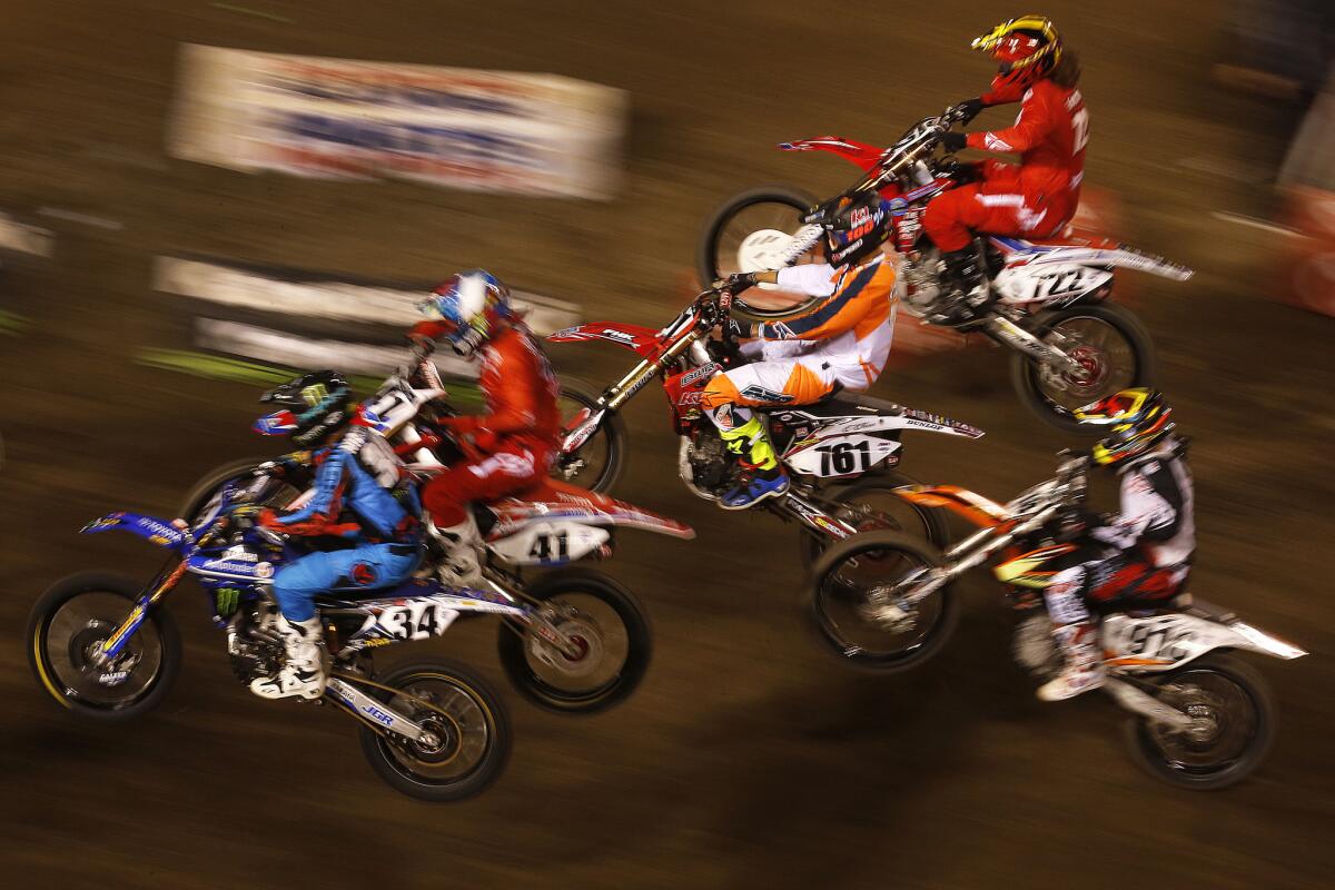 Riders compete in a qualifying heat during the Monster Energy AMA Supercross at Angel Stadium on Jan. 23.
