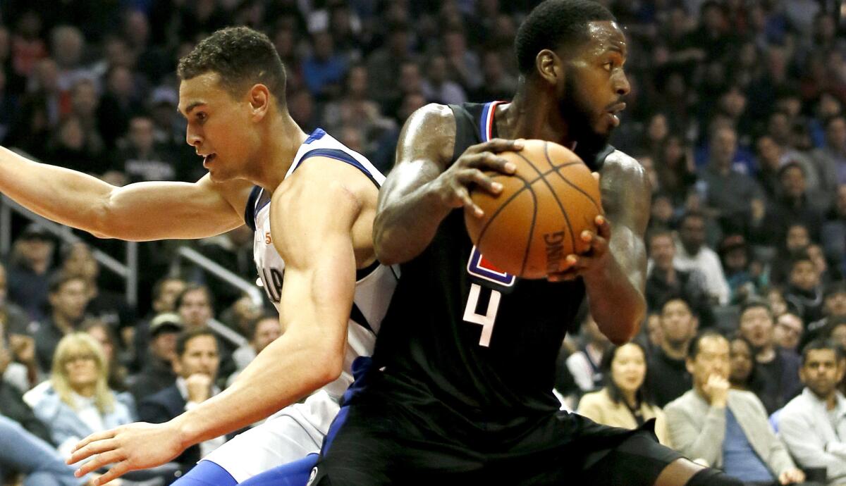 Clippers forward JaMychal Green (4) steals the ball from Mavericks forward Dwight Powell during the first half Monday.