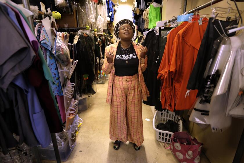 LOS ANGELES, CA- AUGUST 7, 2021 - - Assistant Costume Designer Brittny Chapman is surrounded by costumes on the set of a production she is currently working on at the Fox Studio Lot in Los Angeles on August 7, 2021. (Genaro Molina / Los Angeles Times)