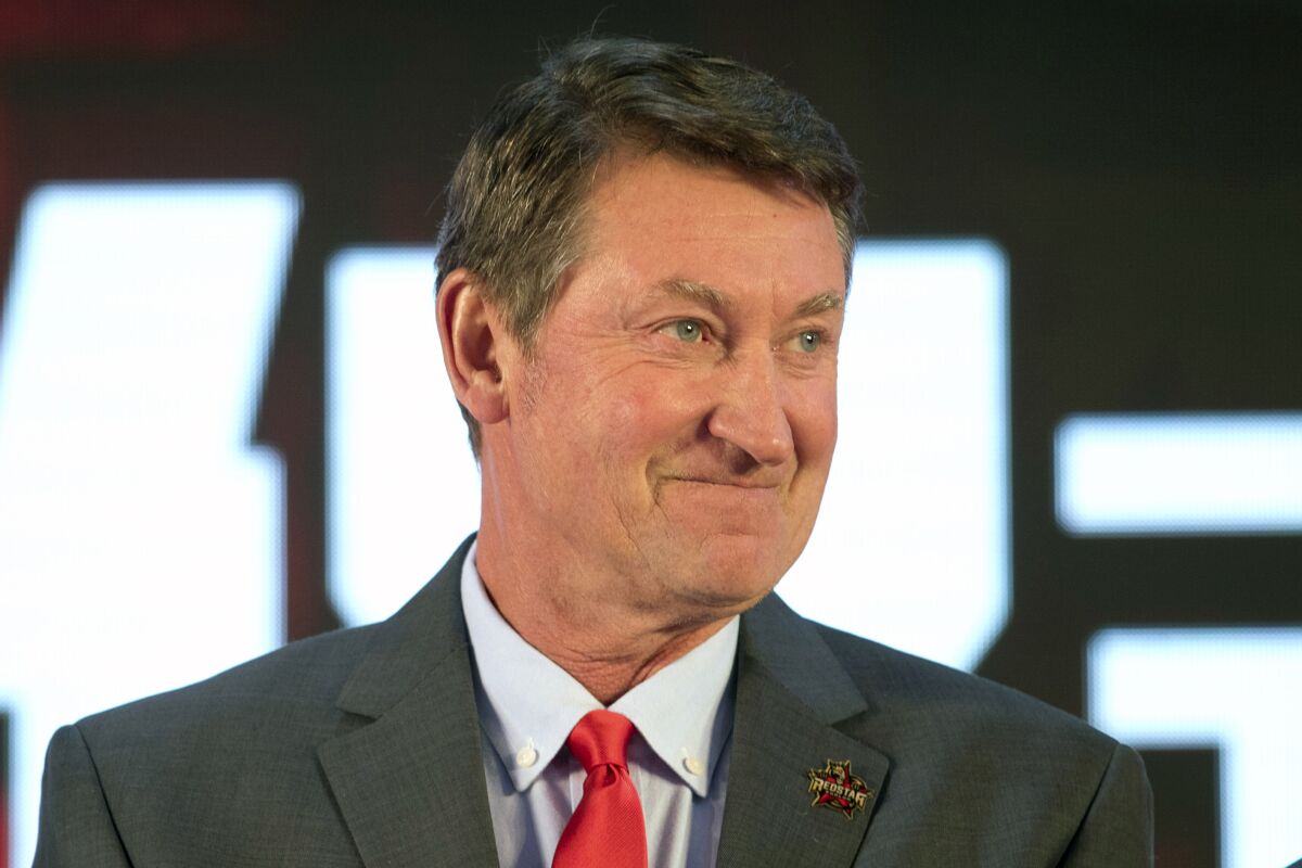 FILE - Former NHL hockey player Wayne Gretzky smiles during a promotional event for the Beijing Kunlun Red Star hockey team in Beijing, in this Thursday, Sept. 13, 2018, file photo. Alex Ovechkin starts a new five-year contract ready to chase Gretzky's career goals record that long seemed unbreakable. The Washington Capitals captain has 730 goals and needs 165 to pass Gretzky. (AP Photo/Mark Schiefelbein, File)