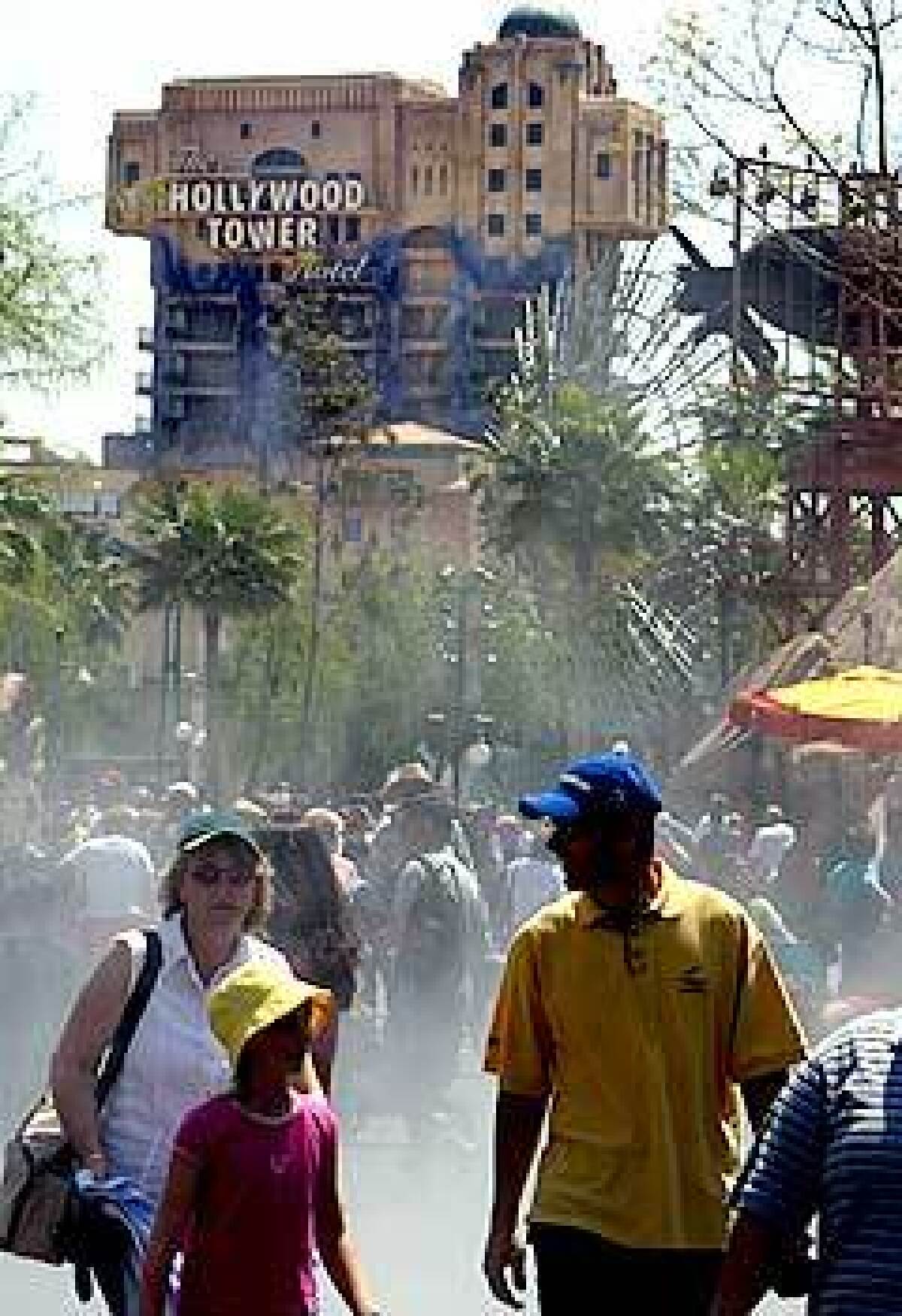 Guests enjoy cool sprays of mist near the Hollywood Tower Hotel, the setting for the Twilight Zone Tower of Terror thrill ride, which is scheduled to open May 5.