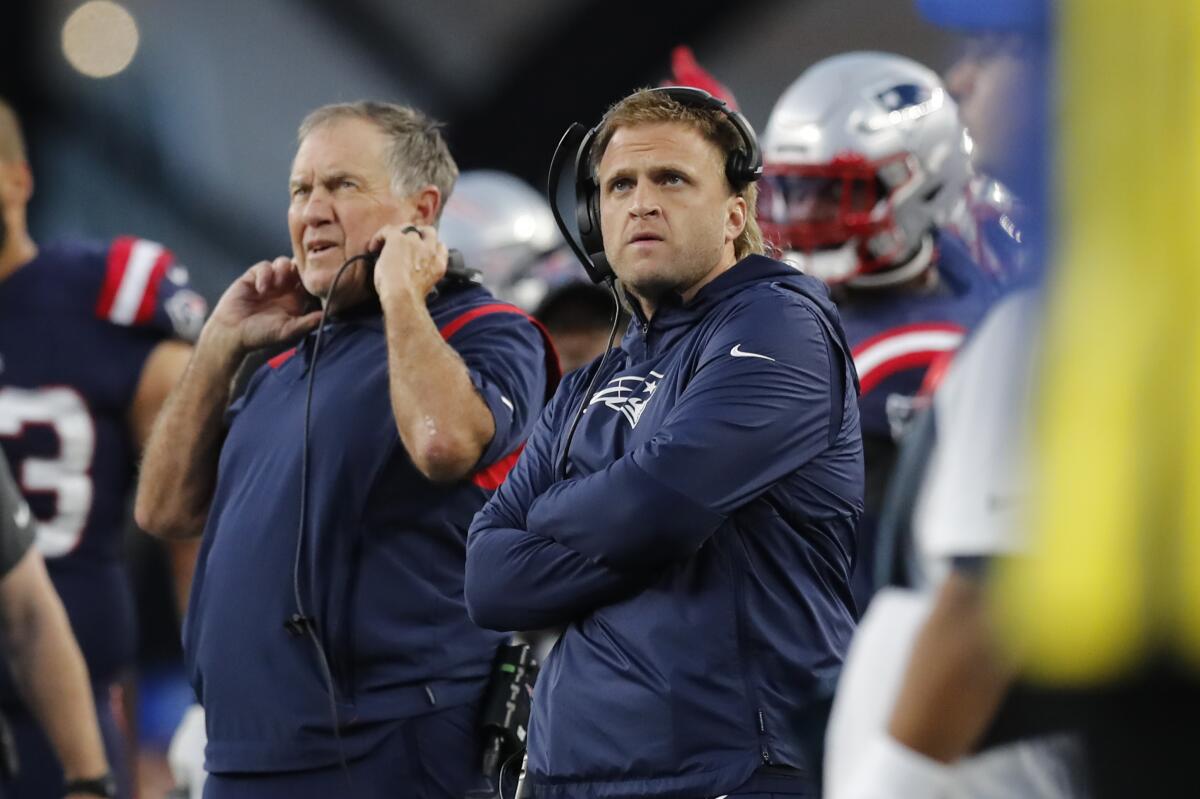 New England Patriots outside linebackers coach Steve Belichick, right, watches a replay with his father, head coach Bill Belichick during the first half of an NFL football game against the Dallas Cowboys, Sunday, Oct. 17, 2021, in Foxborough, Mass. (AP Photo/Michael Dwyer)