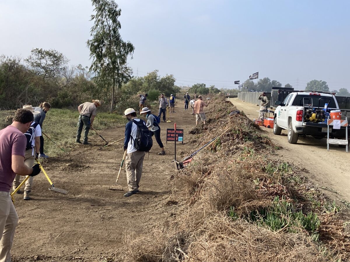 Volunteers at work on the Coast to Crest Trail segment at Surf Sports Park.