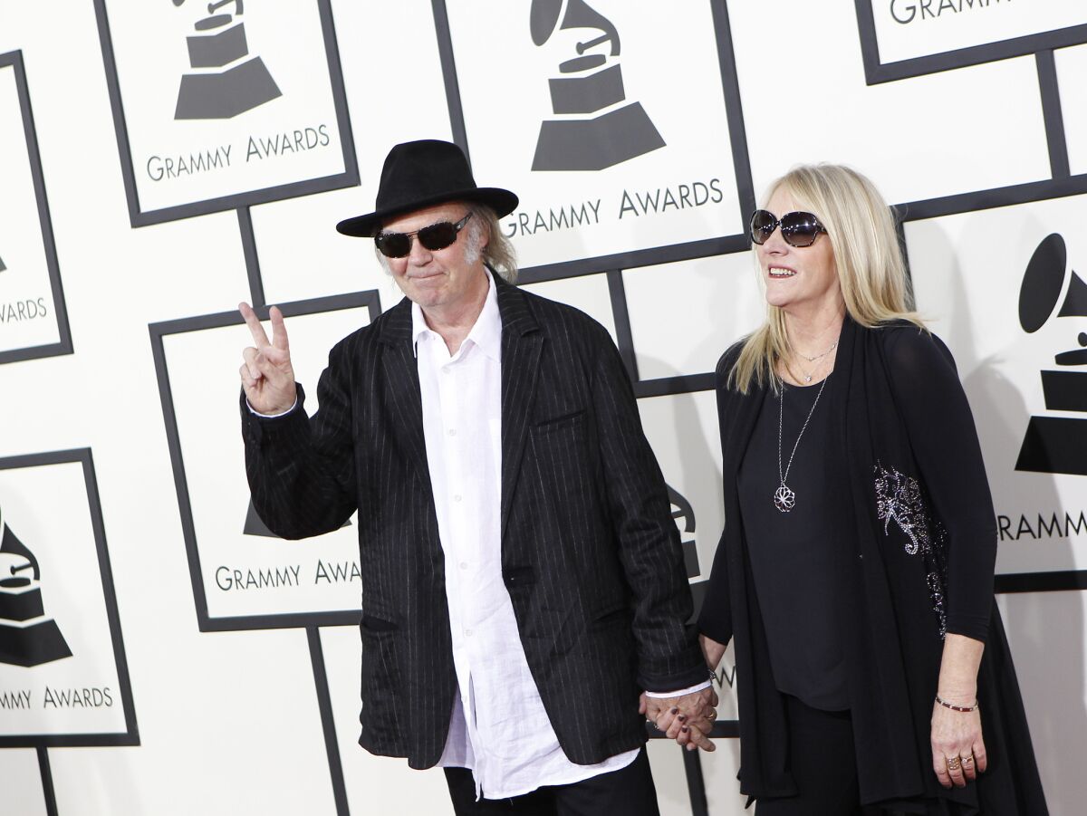 Neil Young and wife, Pegi, arrive for the 56th Annual Grammy Awards.