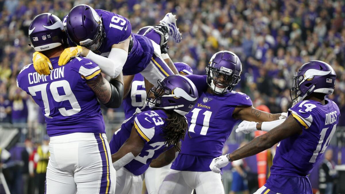 Minnesota Vikings running back Dalvin Cook (33) celebrates with teammates after catching a 26-yard touchdown pass during the first half against the Green Bay Packers.