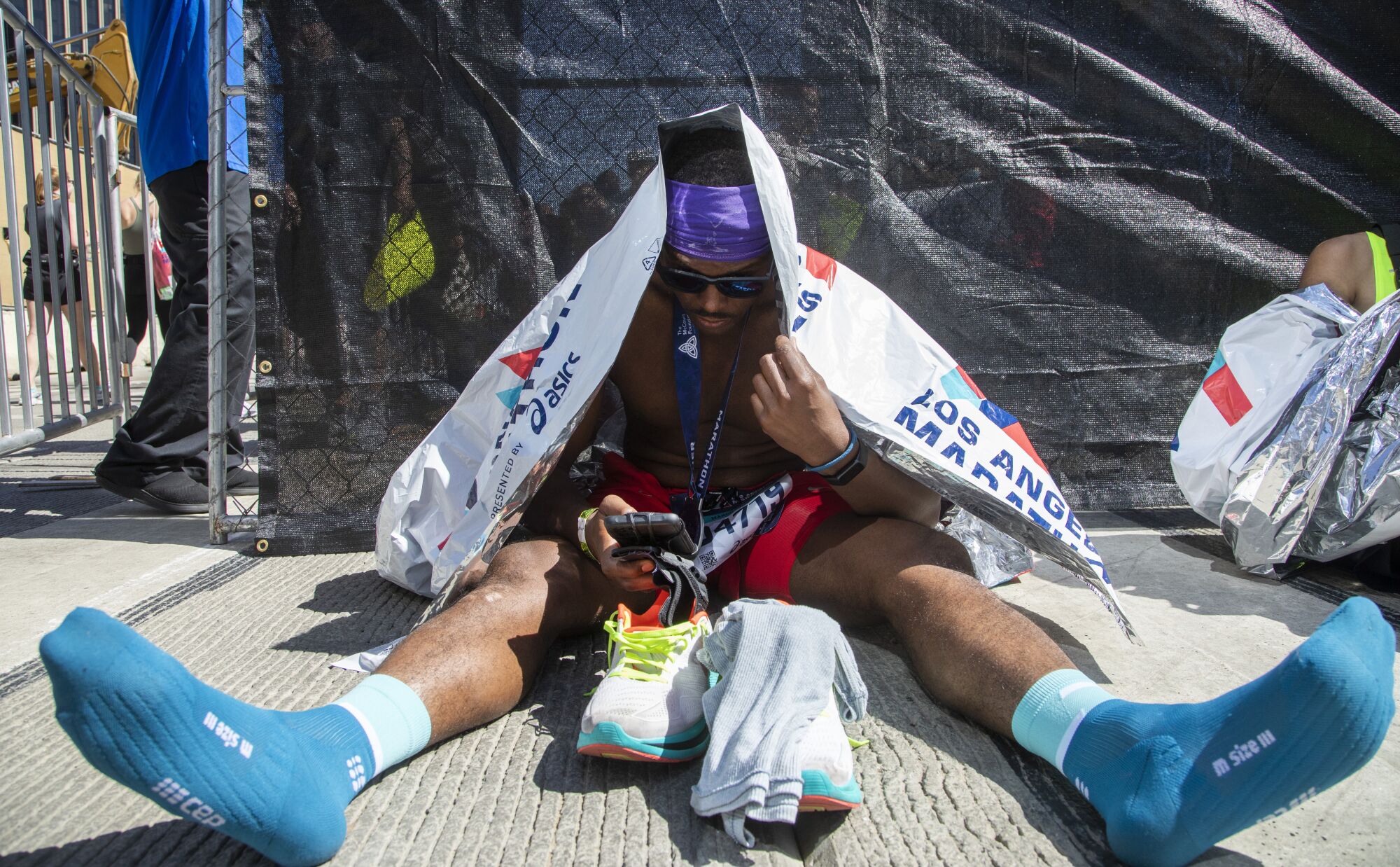 William Howard Bowman of Atlanta rests after finishing his second Los Angeles Marathon.