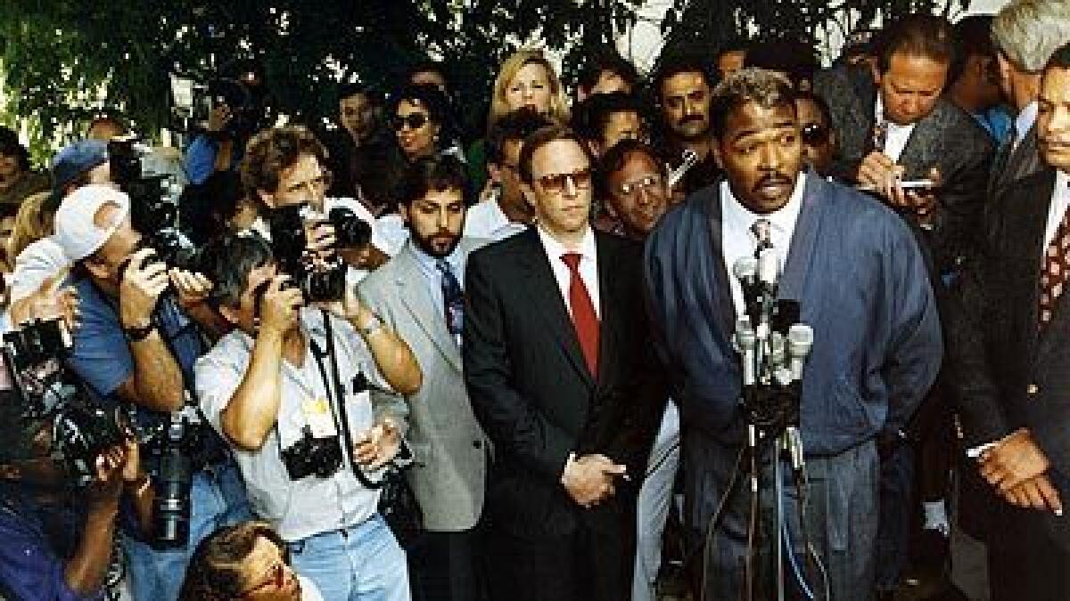 Rodney King, speaking to the media outside of his lawyer's office in Beverly Hills, with a gaggle of press behind him