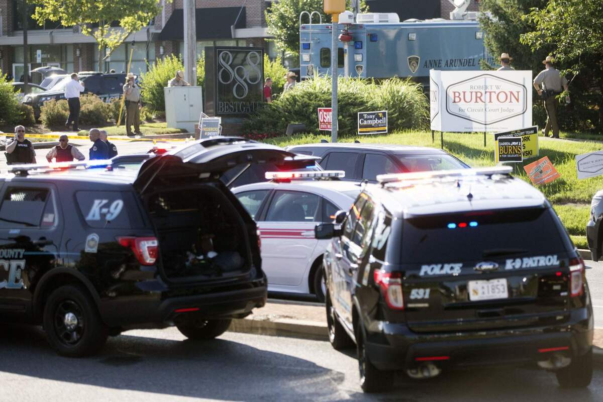 Police gather near the offices of Capital Gazette Communications in Annapolis, Md., after a shooting.