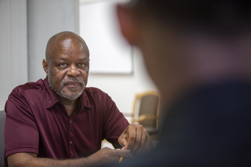 CJ Ford, left, a private investigator/social justice activist, listens to Robert Gardner, right, during a meeting on Monday, October 14.