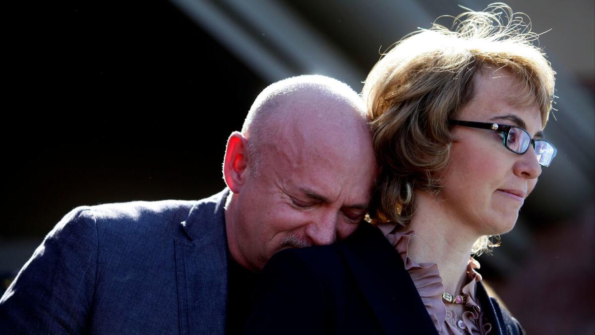 Former U.S. Rep. Gabby Giffords of Arizona and her husband, Mark Kelly, at a 2013 news conference in Tucson where they asked Congress to pass stricter gun control legislation (Joshua Lott / Getty Images)