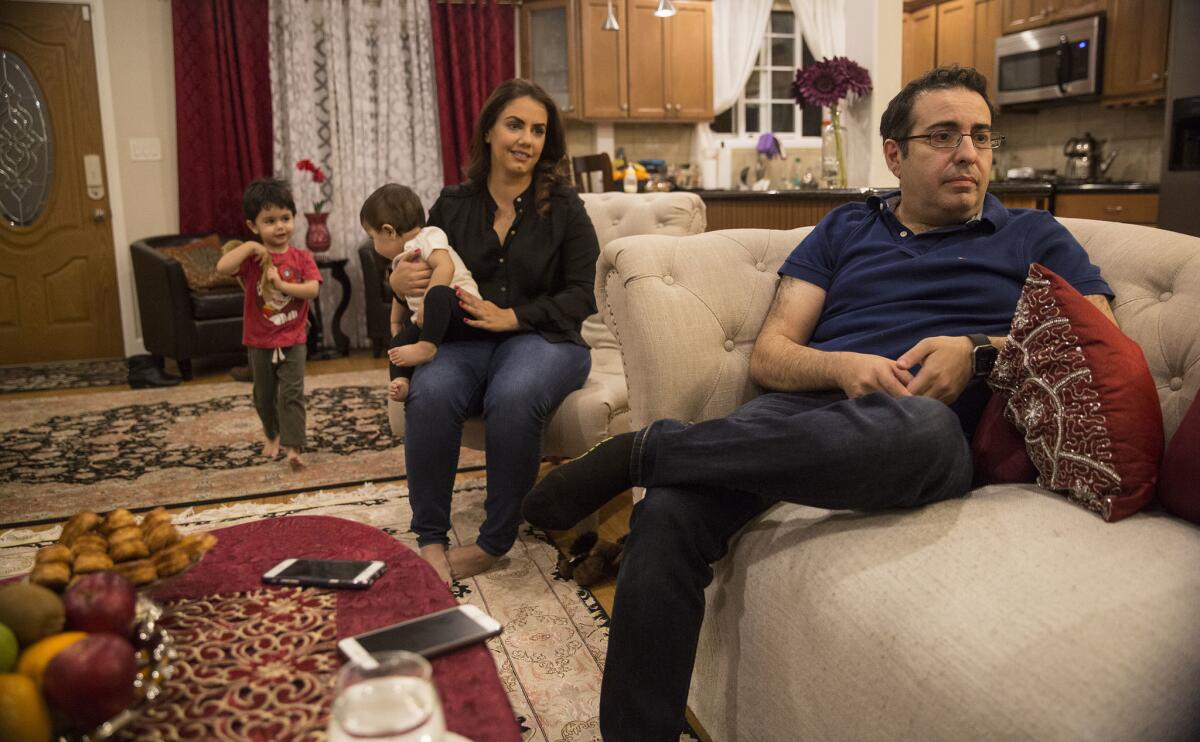 Arian Edalat, right, with wife Samah, son Neema, 3, and daughter Nava, 10 months, talks about the Trump travel ban and his difficulties to bring his mother, a recent visa recipient, to the U.S.