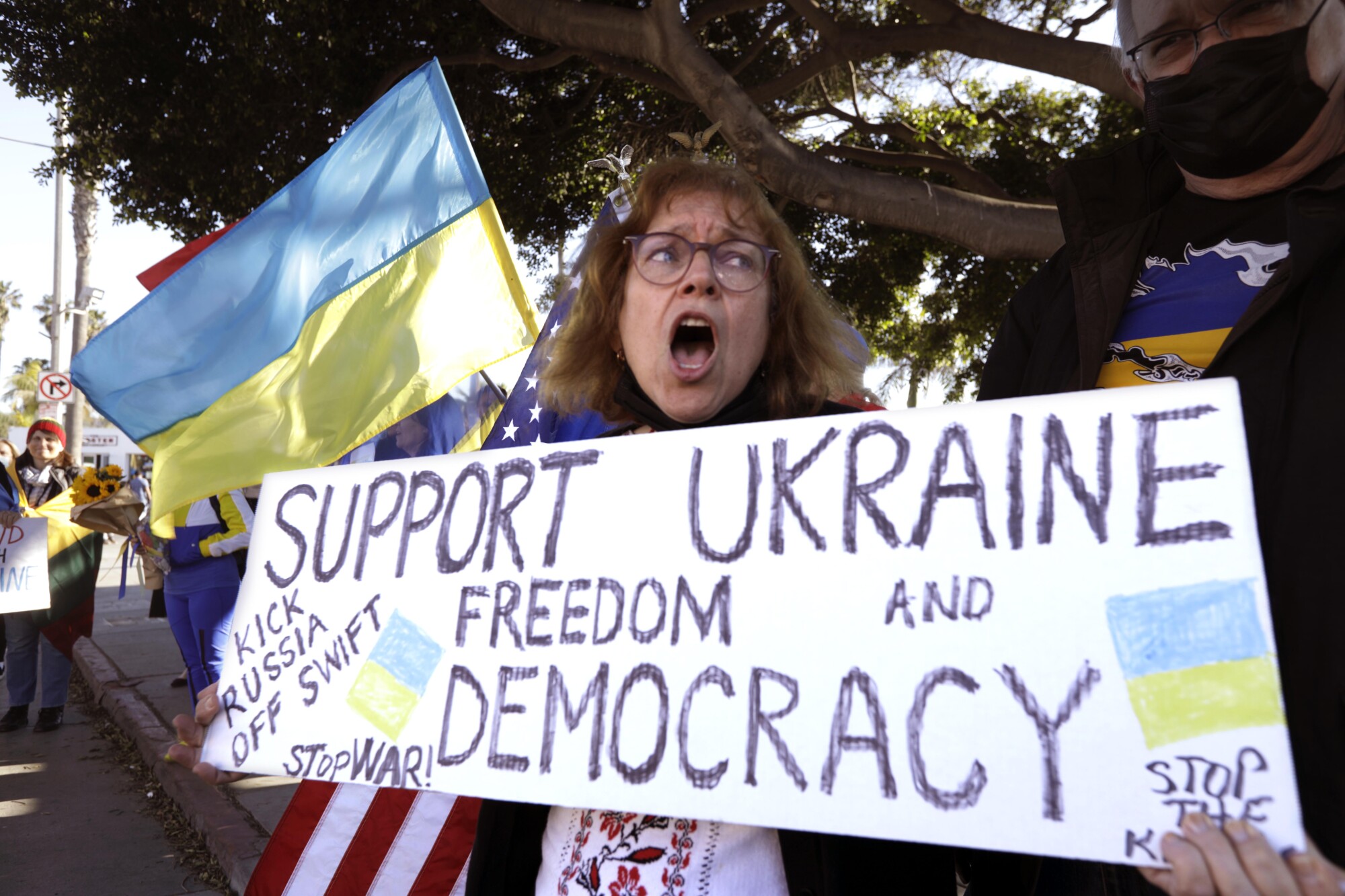 A protester at a rally denounces Russia's invasion of Ukraine near the Santa Monica Pier along Ocean Avenue in Santa Monica