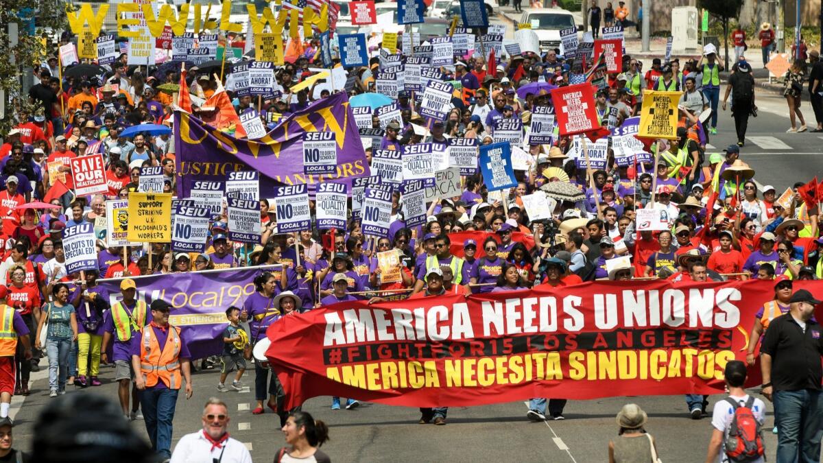 Demonstrators march through downtown Los Angeles during a 2017 Labor Day protest organized by the SEIU in support of a $15 hourly wage.
