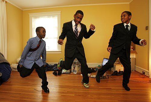 The Davis brothers -- from left, Tyrique, 8; Treyton, 14; and Theodore, 13 -- dance together in their living room. Their mother, Staff Sgt. Carletta Davis, 34, was killed in Iraq in early November. They live in Oswego, N.Y., with their father, Thomas, a physician's assistant.