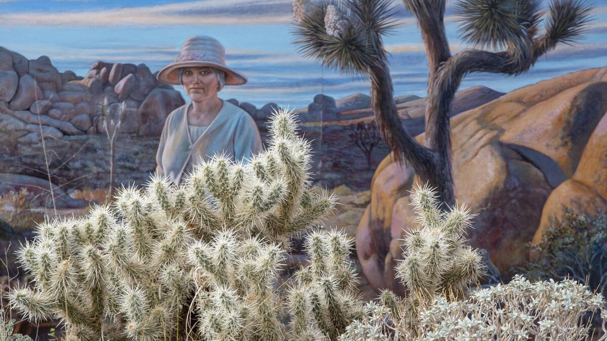 JOSHUA TREE NATIONAL PARK, CALIF. -- MONDAY, NOVEMBER 19, 2018: A mural featuring Minerva Hamilton Hoyt seems to peer over a Cholla cactus at the Joshua Tree National Park visitor center of in Twentynine Palms Calif., on Nov. 19, 2018. (Brian van der Brug / Los Angeles Times)