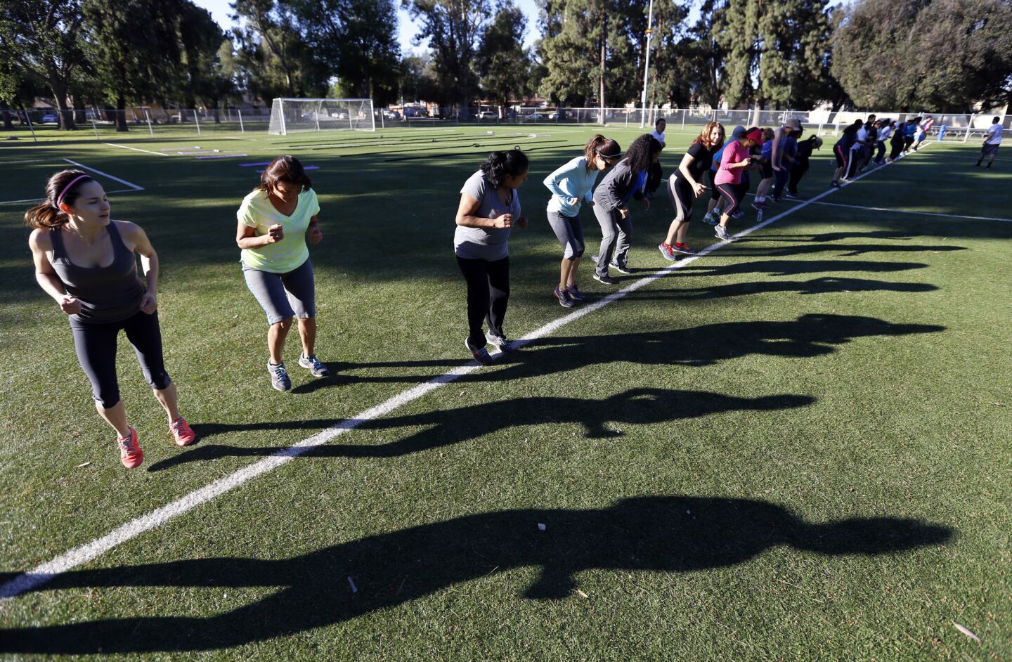 As a heat wave hits Southern California, students work out during an exercise class in Lanark Park.