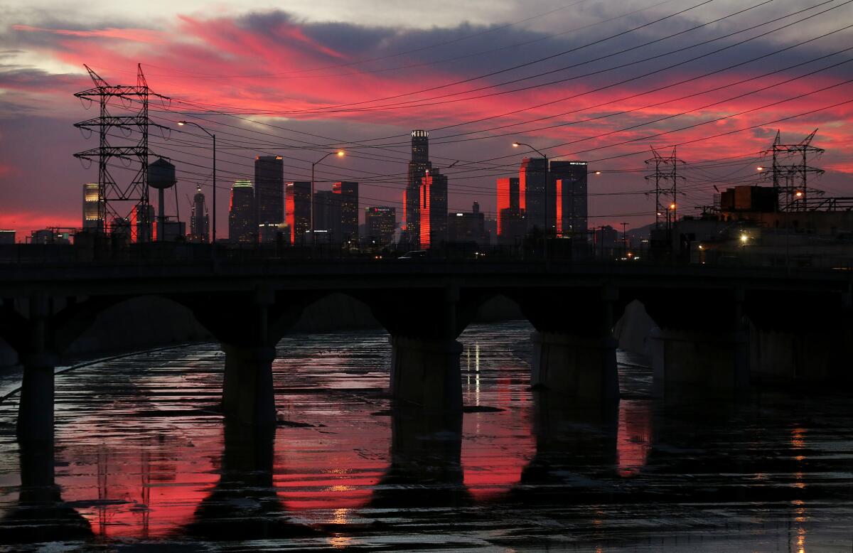 The Los Angeles River reflects late afternoon light as it flows beneath the Soto Street Bridge in Boyle Heights.
