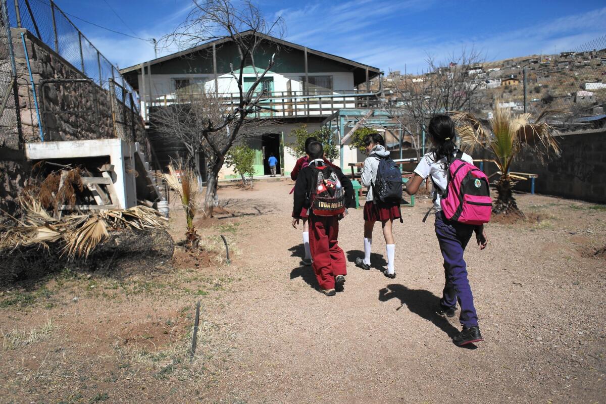 Schoolchildren arrive for lunch at a kitchen run by Home of Hope and Peace, a nonprofit group, in Nogales, Mexico. To attend school in Mexico, students must have proper documents, which many U.S.-born children of returning Mexicans lack.