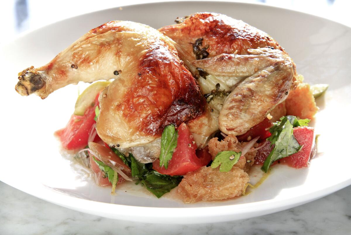 According to Google, chicken recipes were the most-searched-for recipes of 2014. Pictured is a wood roasted half chicken with heirloom tomato bread salad served at Tar & Roses restaurant.