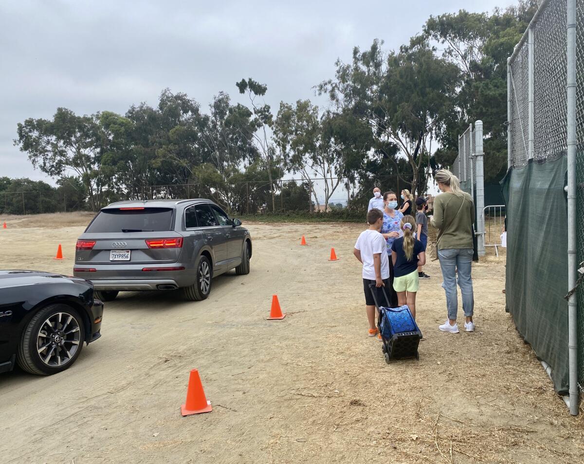 Students arriving at San Diego French American School undergo health screenings in staggered arrival times.
