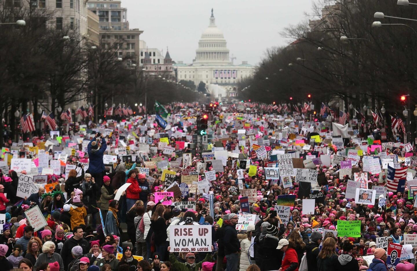 Protesters walk during the Women's March on Washington, with the U.S. Capitol in the background, on January 21, 2017 in Washington, DC. Large crowds are attending the anti-Trump rally a day after U.S. President Donald Trump was sworn in as the 45th U.S. president.